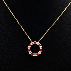 ruby and diamond pendant on black background