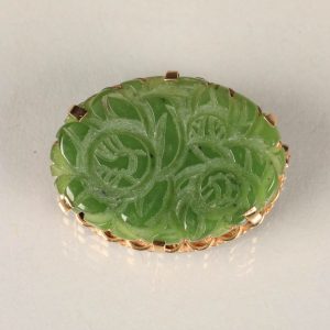 Gold carved jade brooch