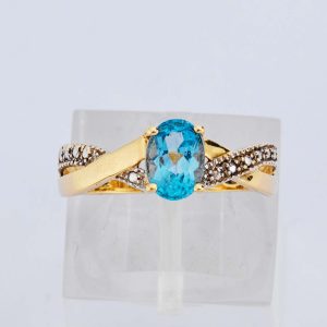 Oval Blue Stone Crossover Gold Ring